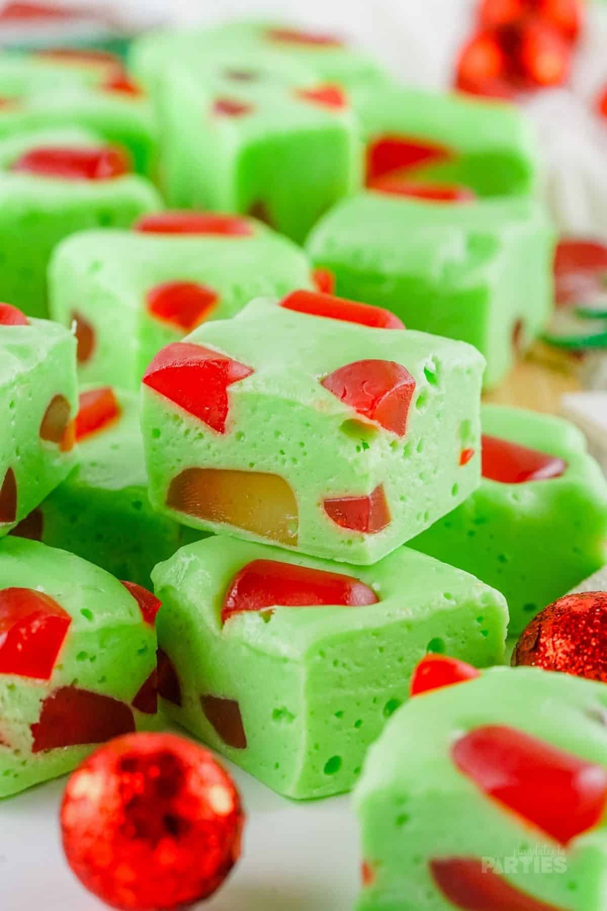 Red and green Christmas nougat scattered on a white surface.