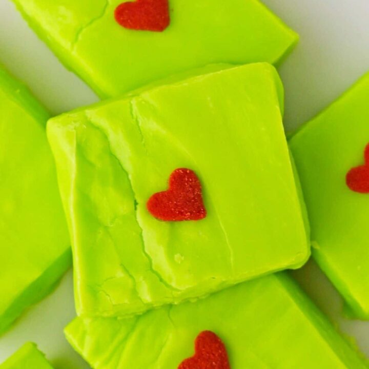 A square of green Grinch fudge with a single candy heart.