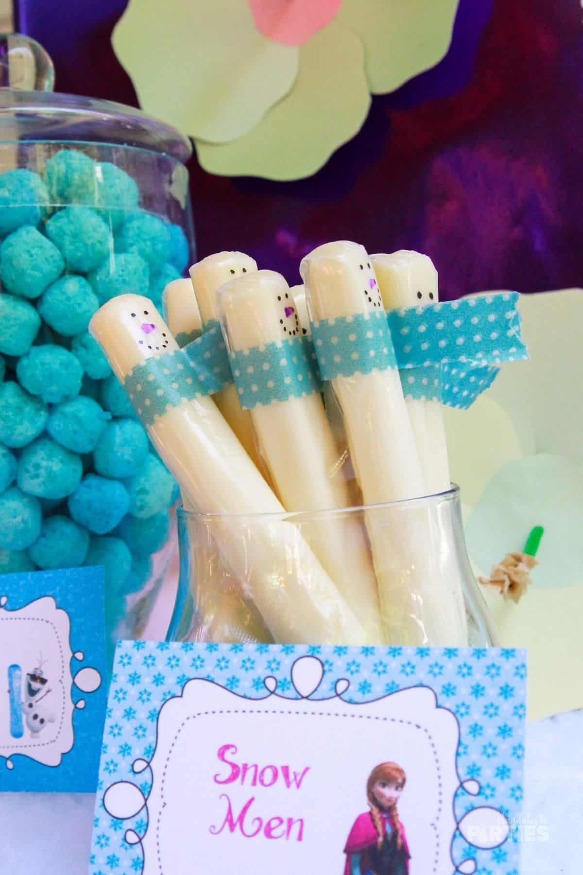 Cheese stick snowmen displayed at a Frozen themed party.