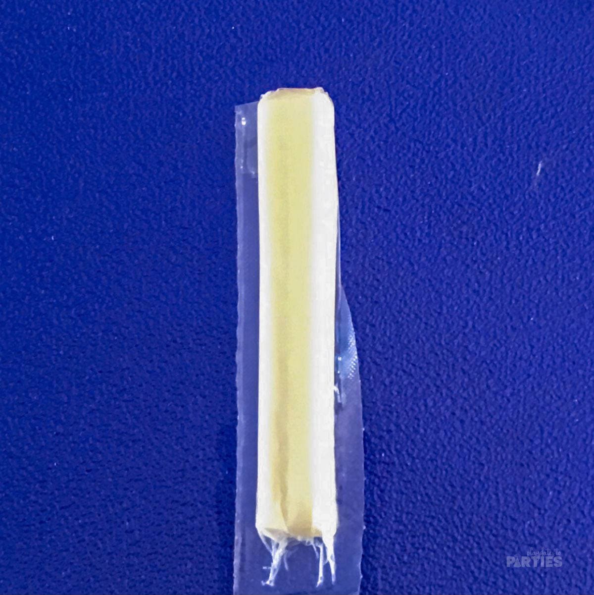 Folding the flaps back on the string cheese.