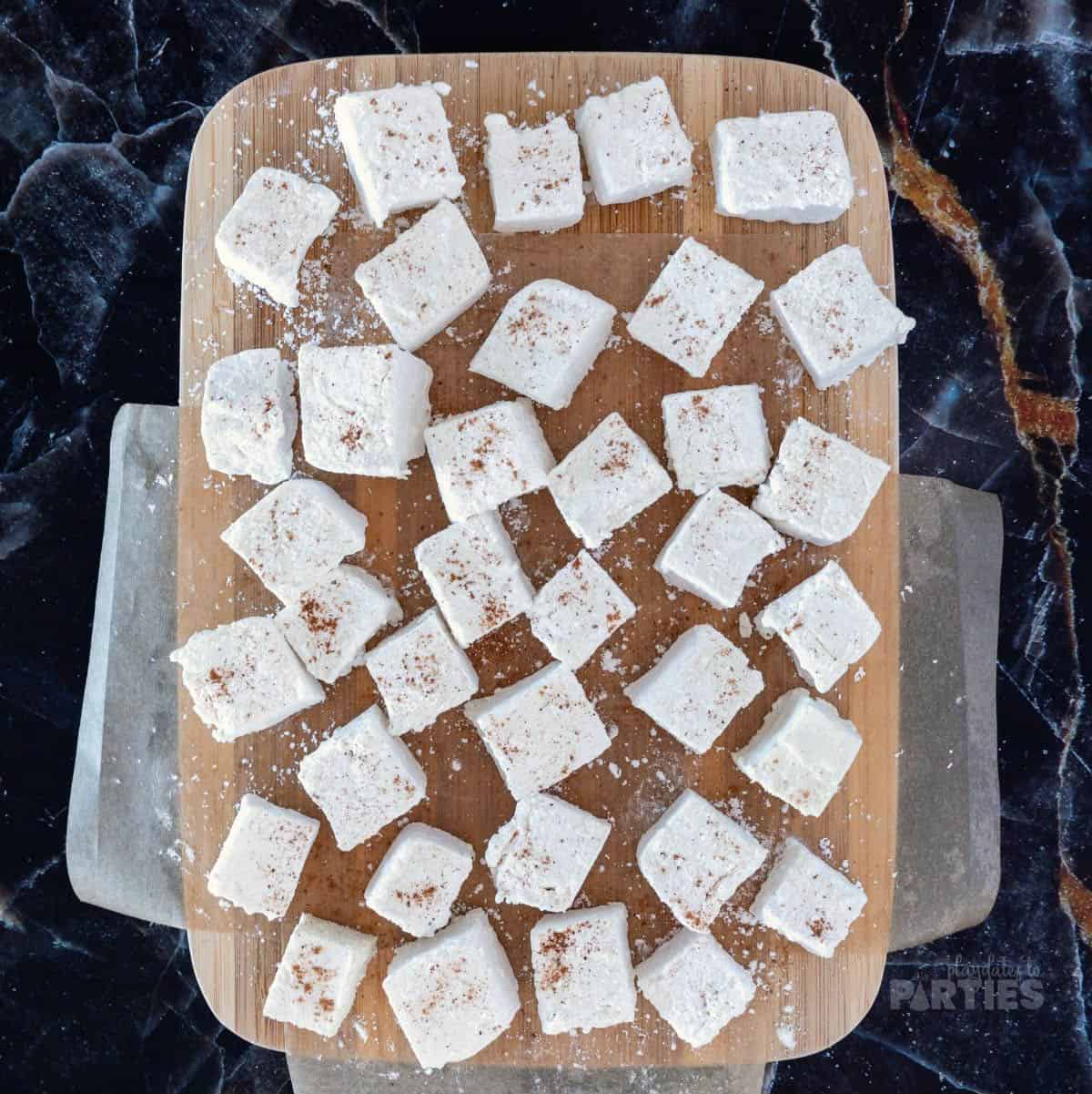 Homemade marshmallows on a cutting board.
