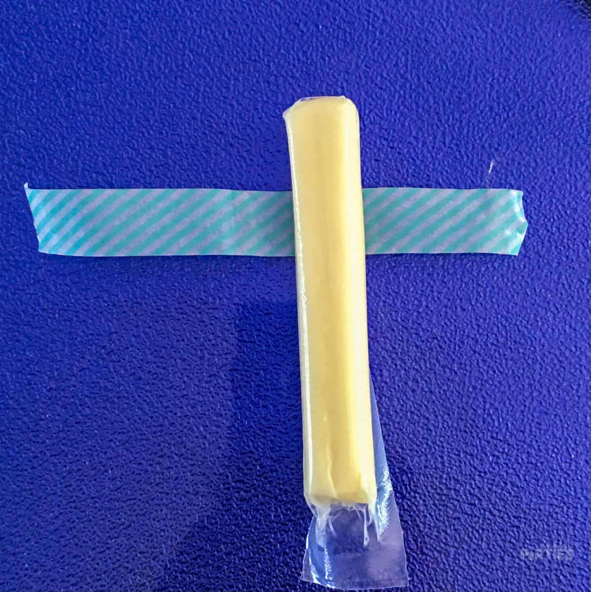 String cheese sitting on top of a piece of washi tape.