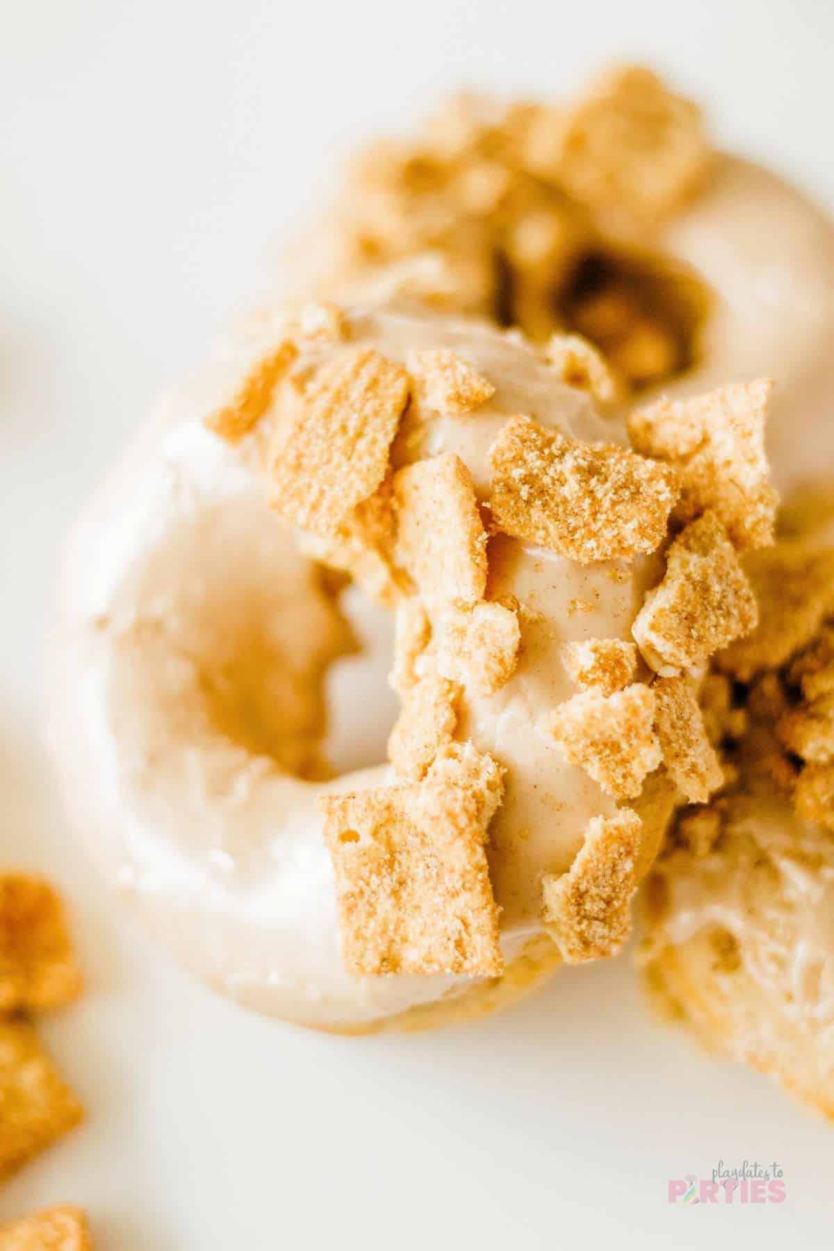 The shiny glaze and crushed cereal add sweetness and crunch to the donuts