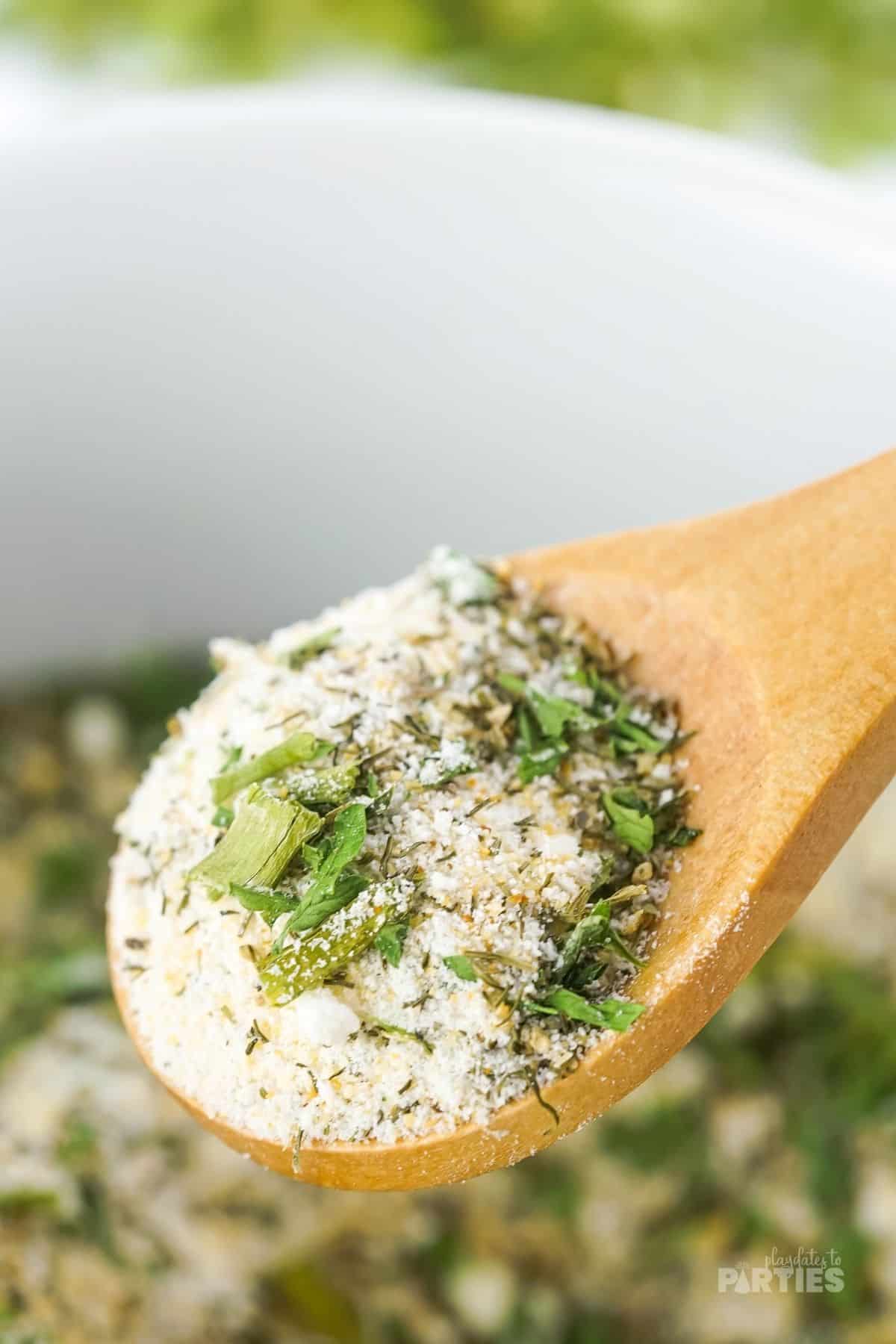 Homemade Ranch seasoning in a wooden spoon.