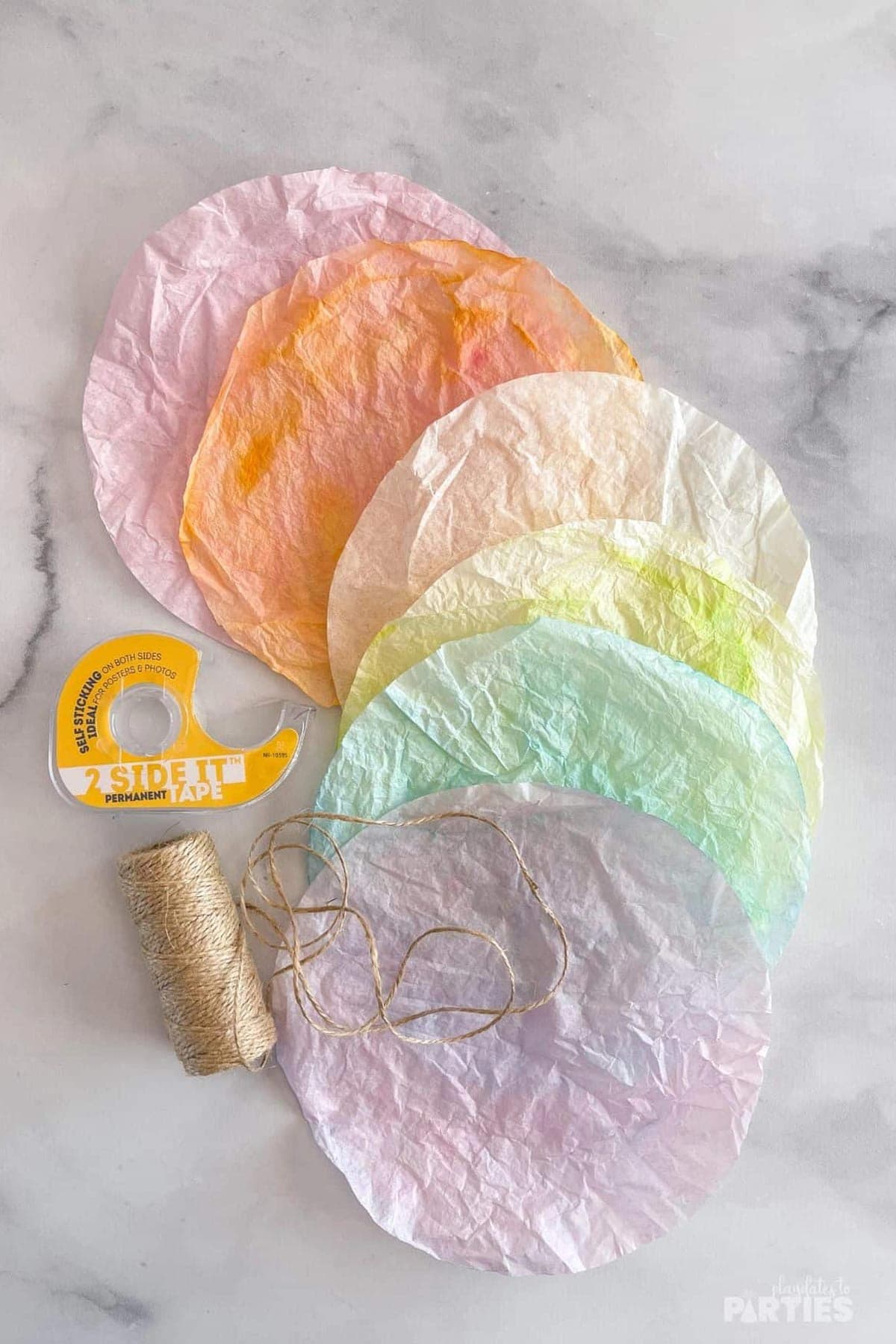 Coffee filter banners are made with colored coffee filters, twine, and tape.