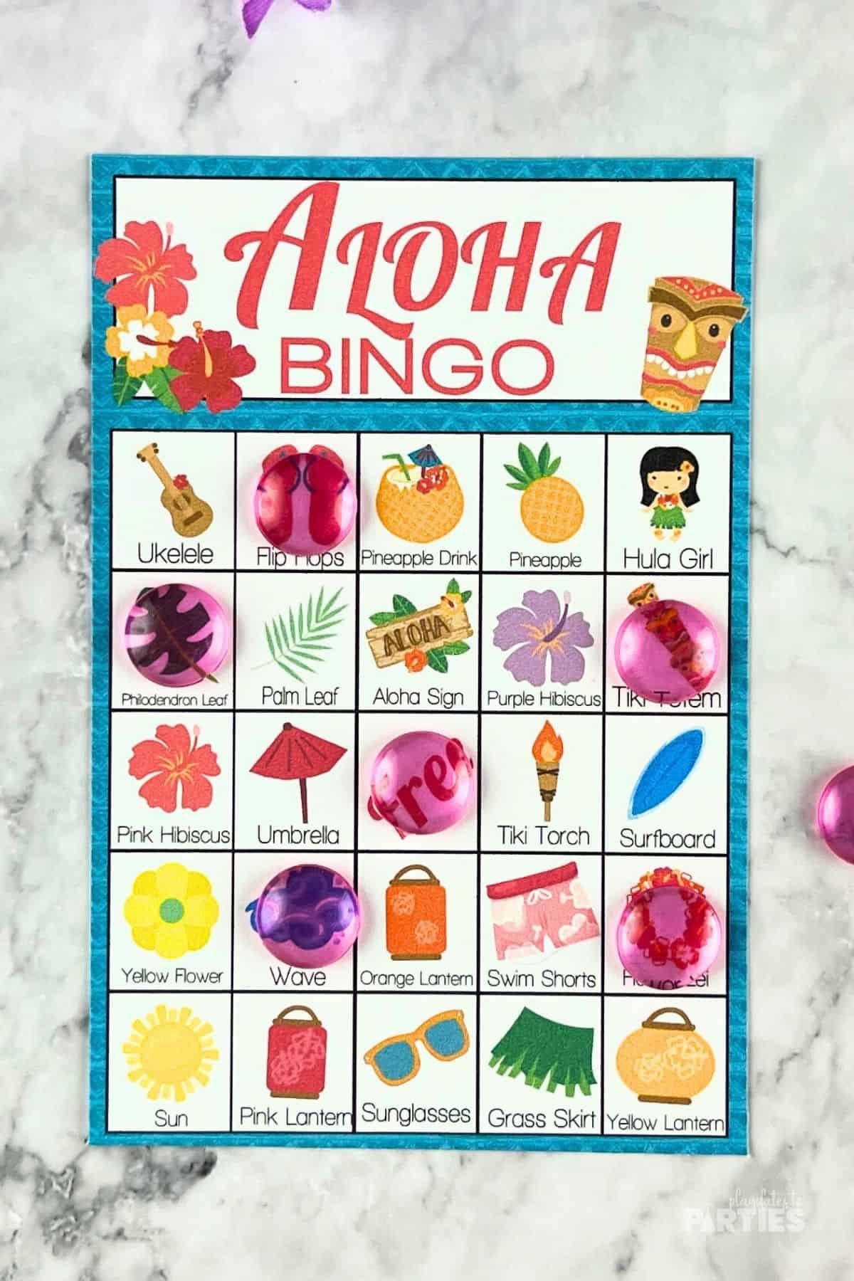 Aloha bingo card with markers for a Luau party.