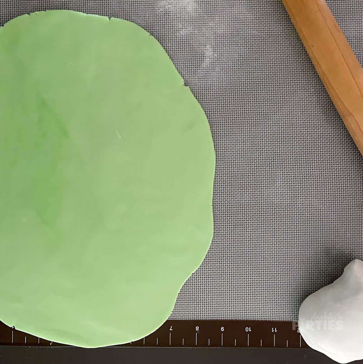 Fondant rolled out on a silicone mat.