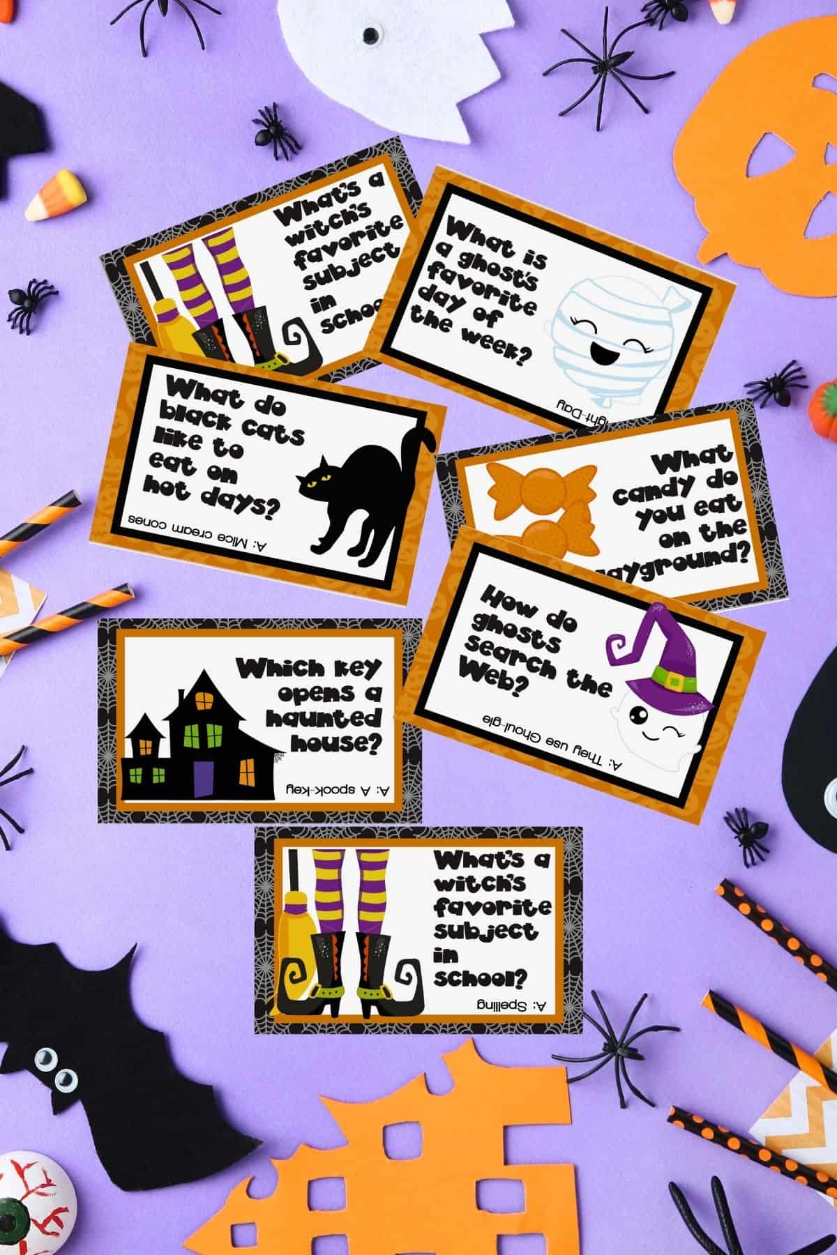 Printable Halloween Lunch Box Joke Cards on a purple surface.