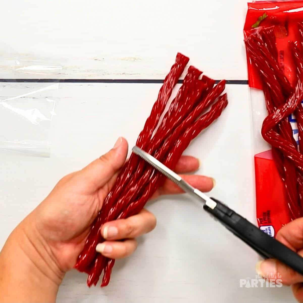 Step 2 - cutting the Twizzlers in half.