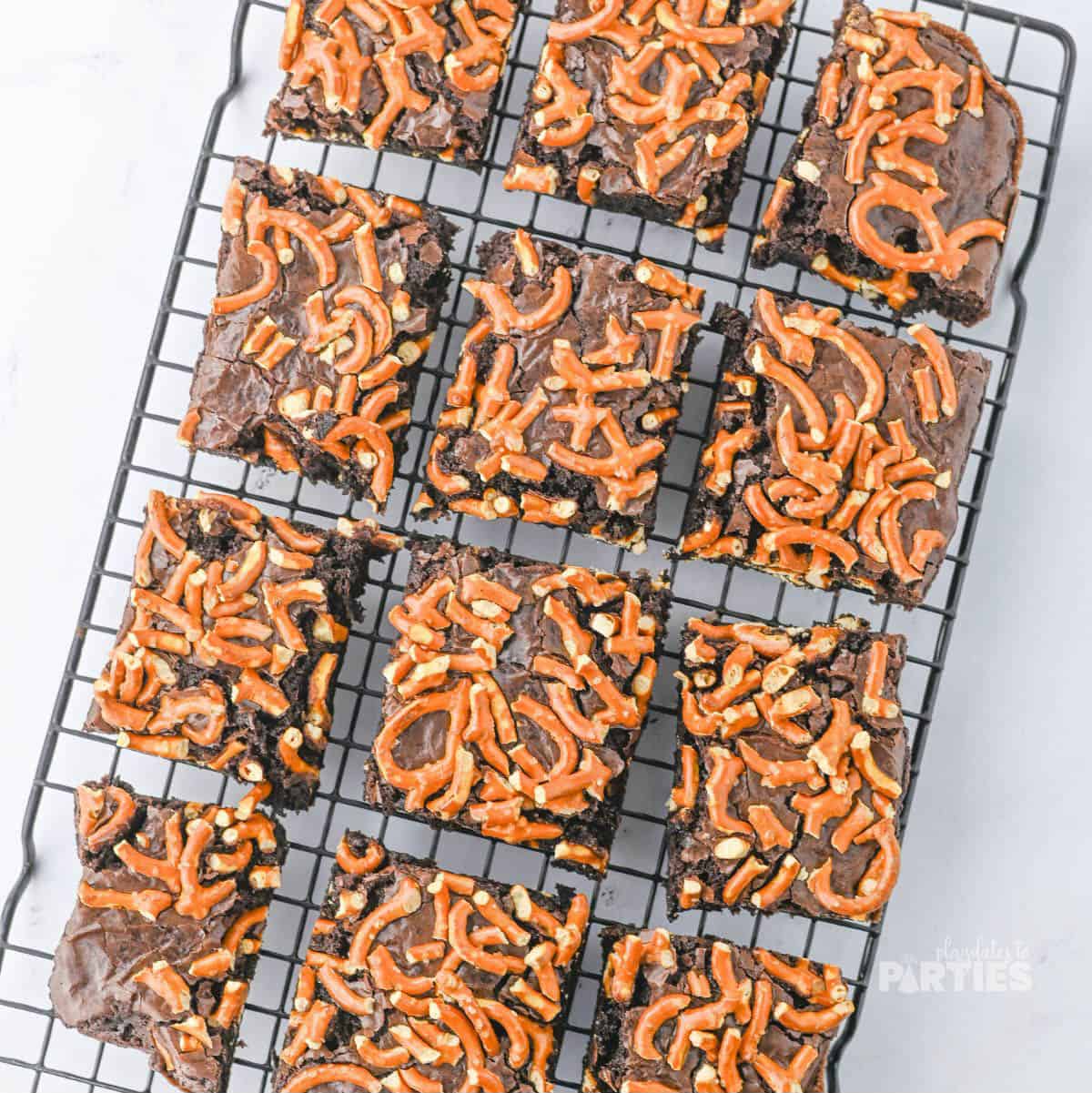 Baked brownies cut and on a cooling rack.