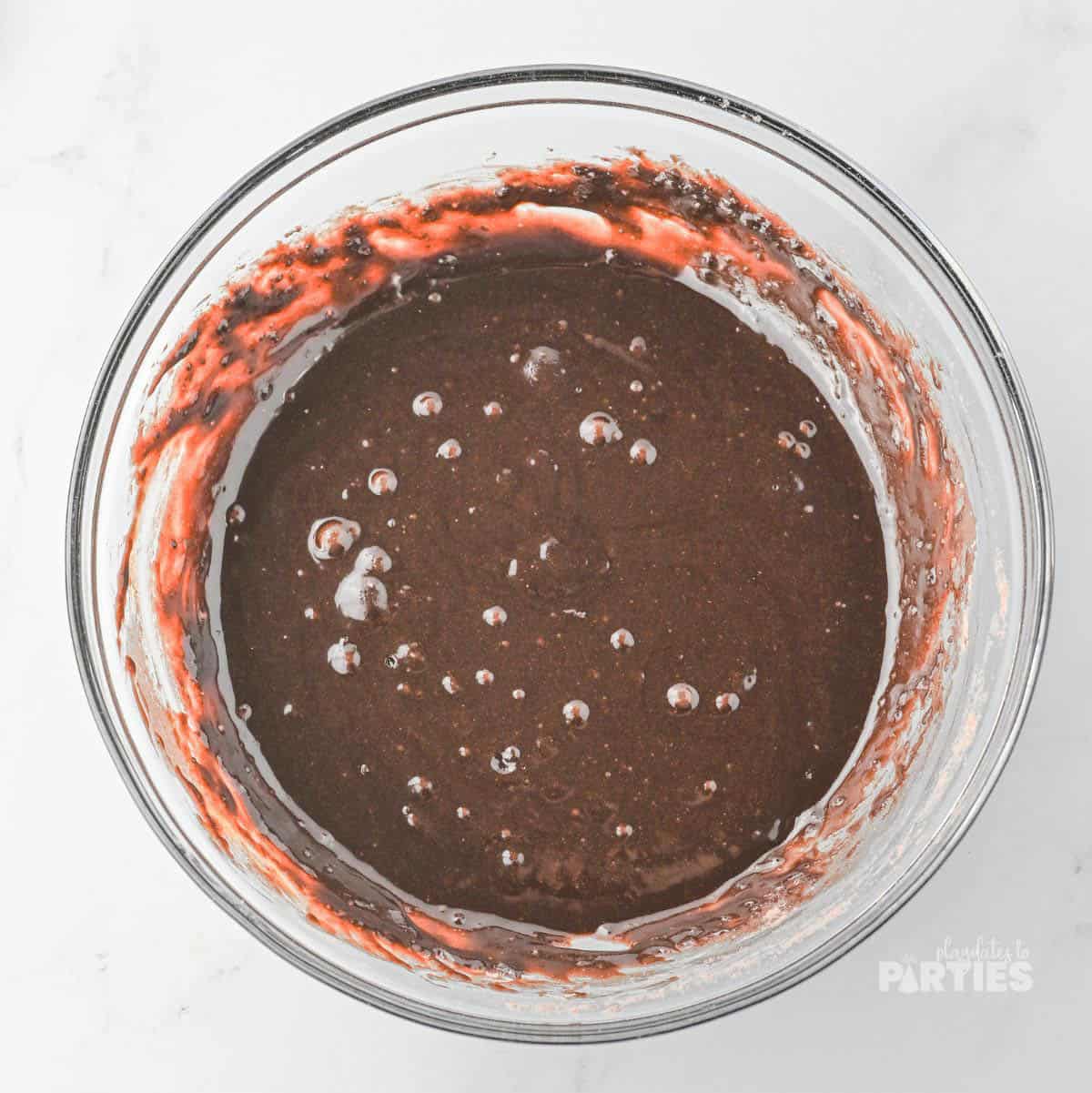 Brownie batter in a glass bowl.