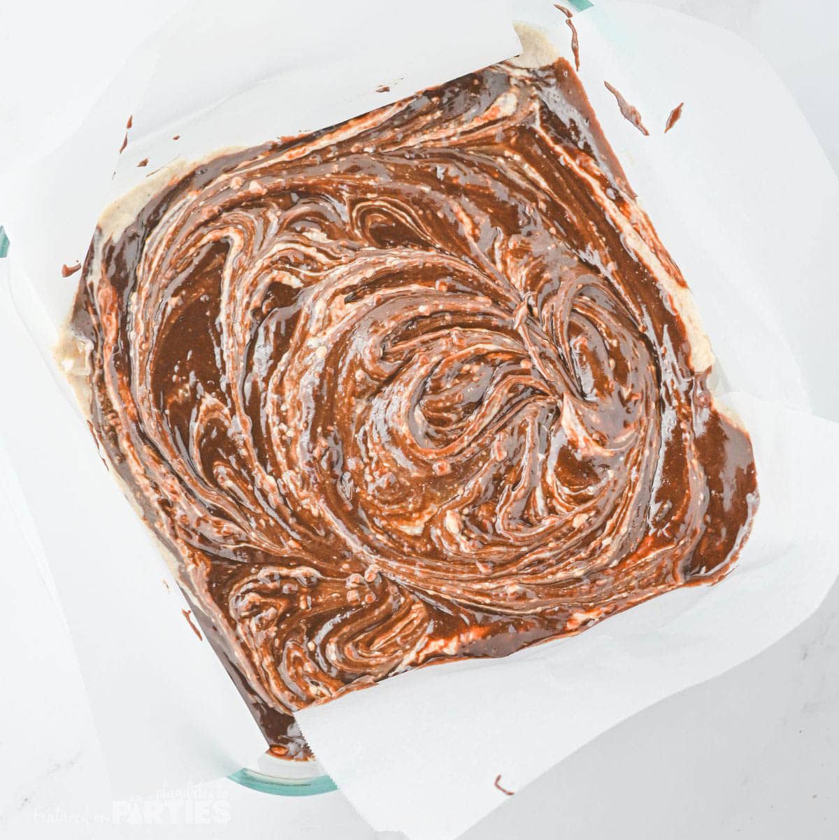Brownie batter layered with creamy eggnog and more brownie batter on top.
