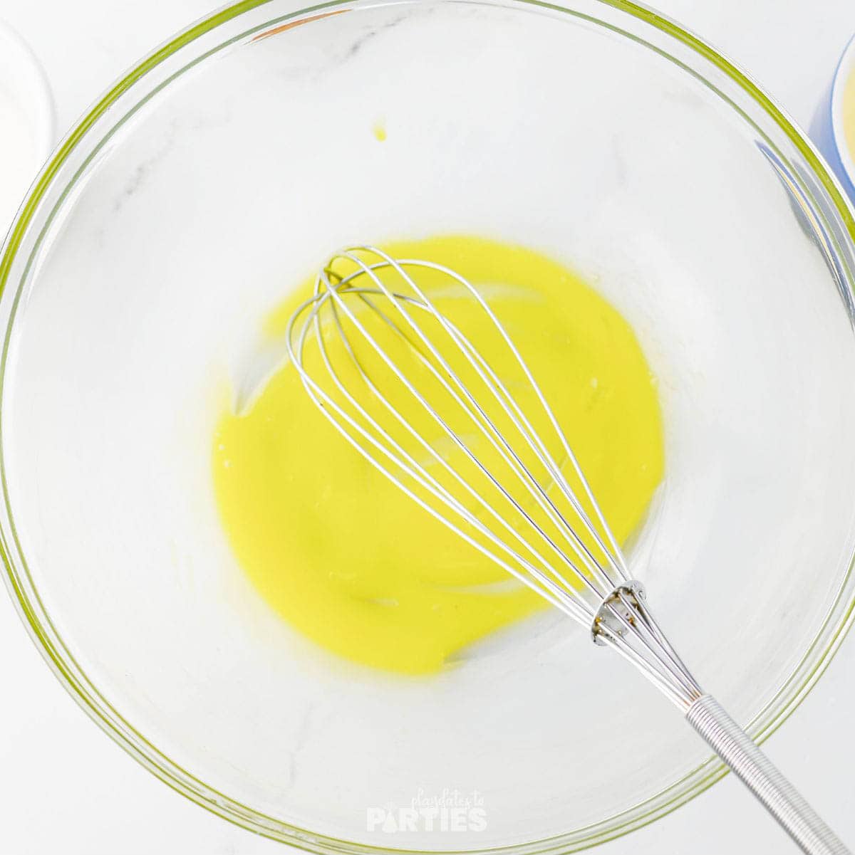 Whisking an egg in a mixing bowl.