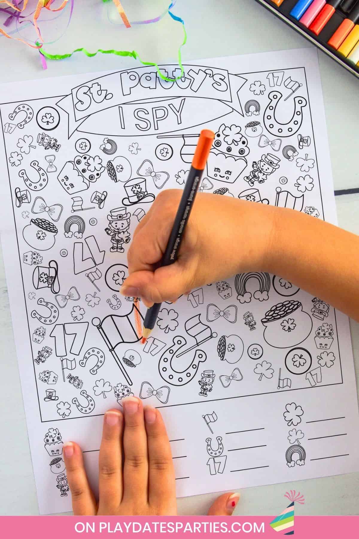 A child coloring in a black and white version of St Patricks Day I Spy.