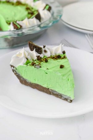 A slice of Grasshopper pie on a white plate.