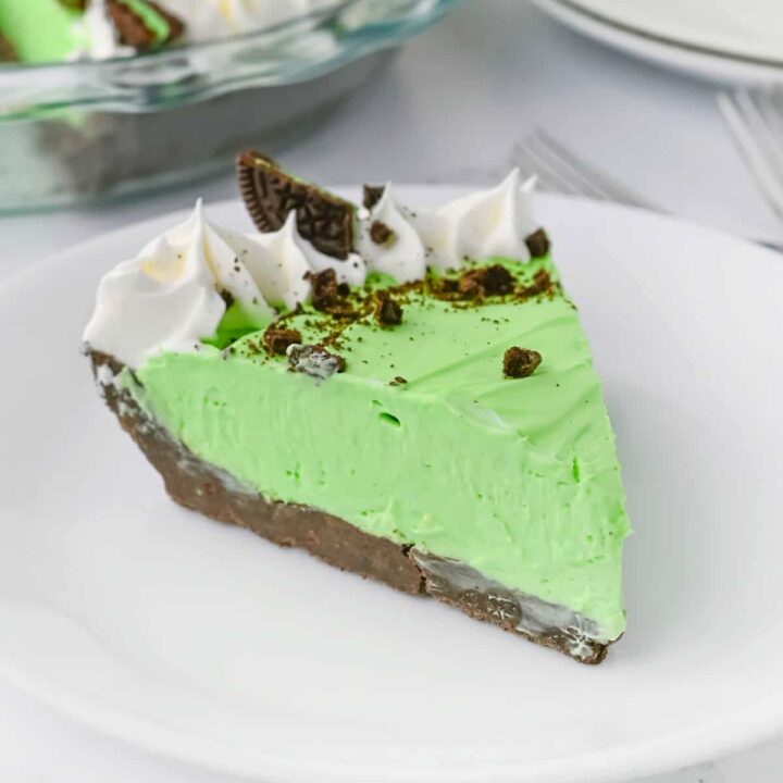 A slice of Grasshopper pie on a white plate.