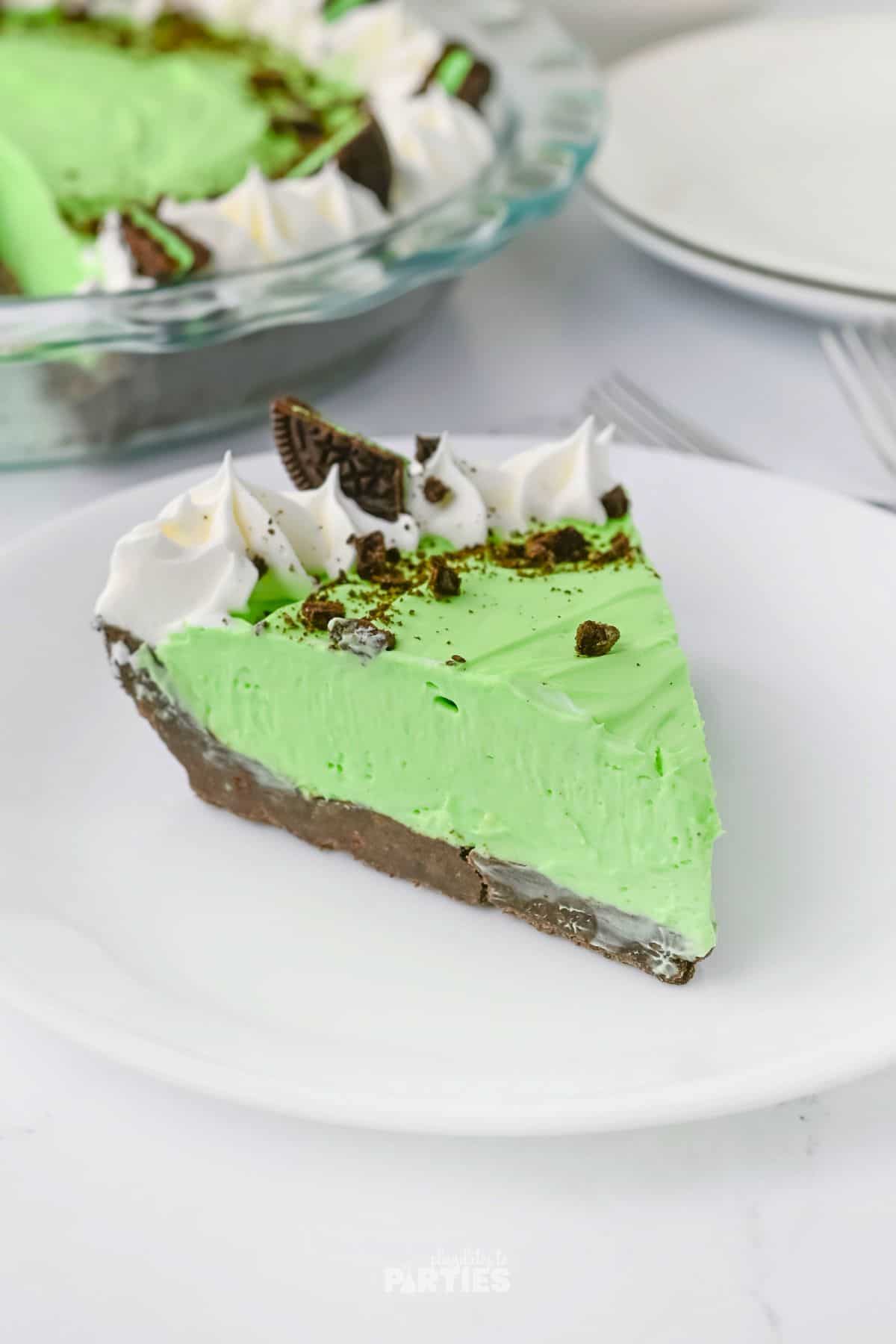 A slice of Grasshopper pie on a white plate.
