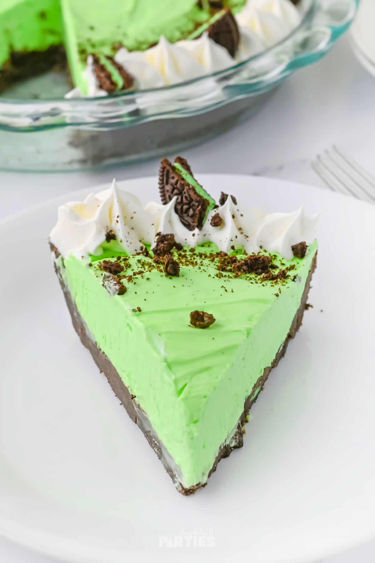 A slice of Grasshopper pie on a white plate.