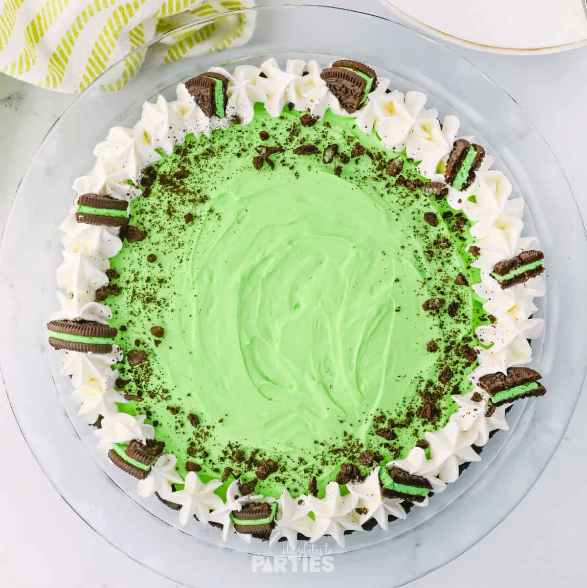 Finished grasshopper pie with whipped cream and mint Oreo cookies.