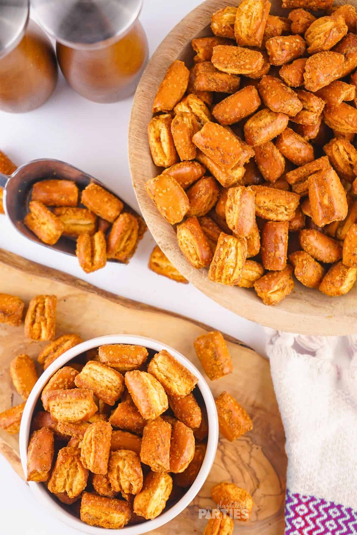 Two serving bowls filled with seasoned pretzel pieces.