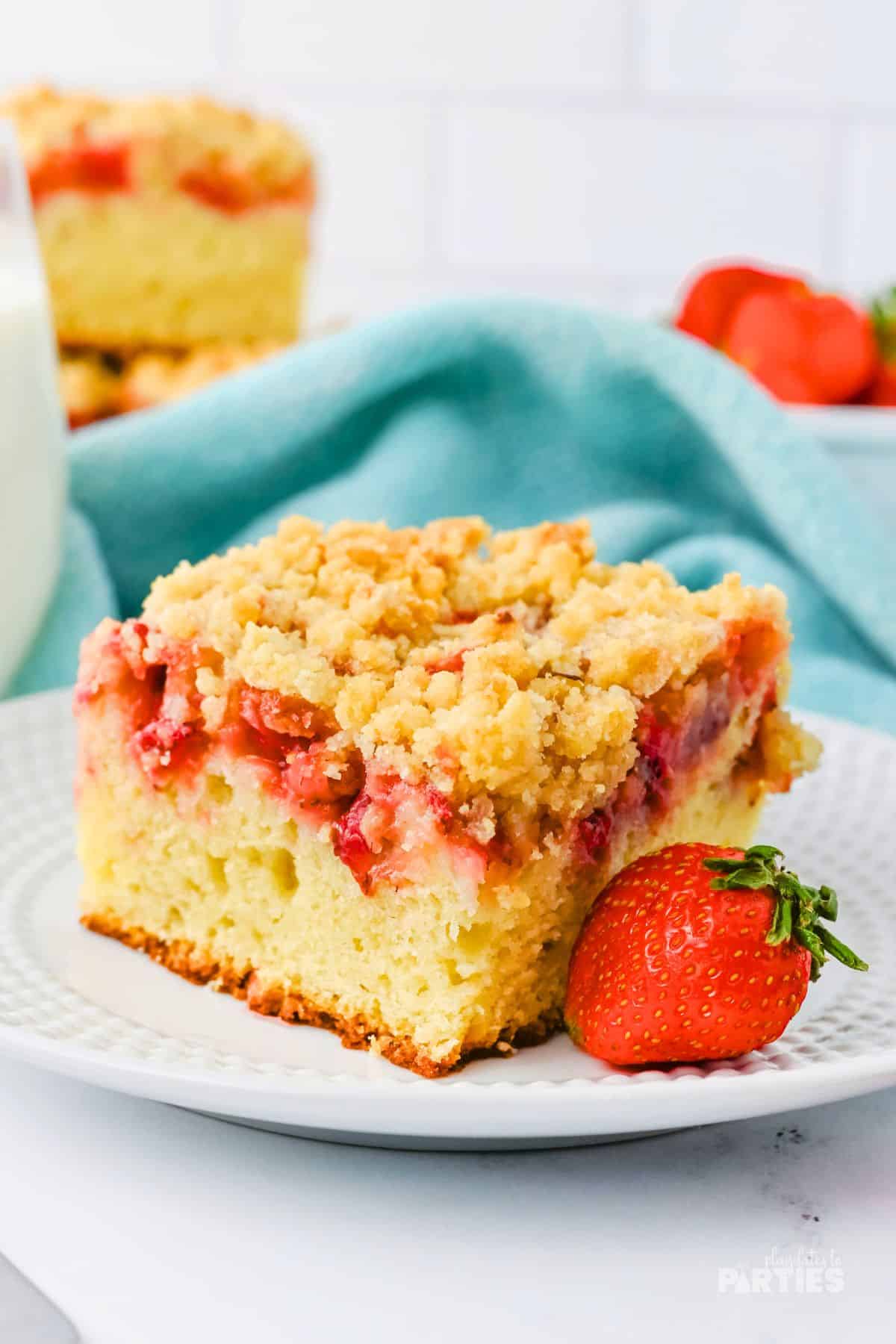 A slice of strawberry crumb cake on a plate.