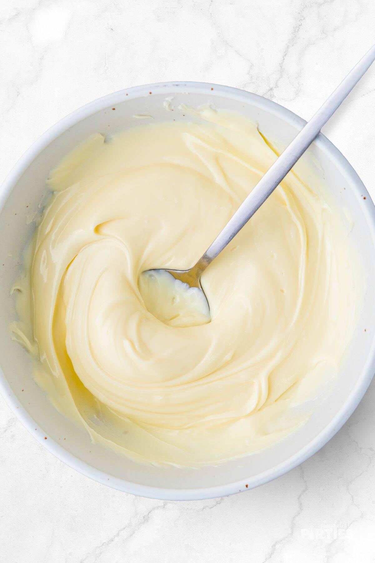 Almond bark melted in a bowl until smooth.