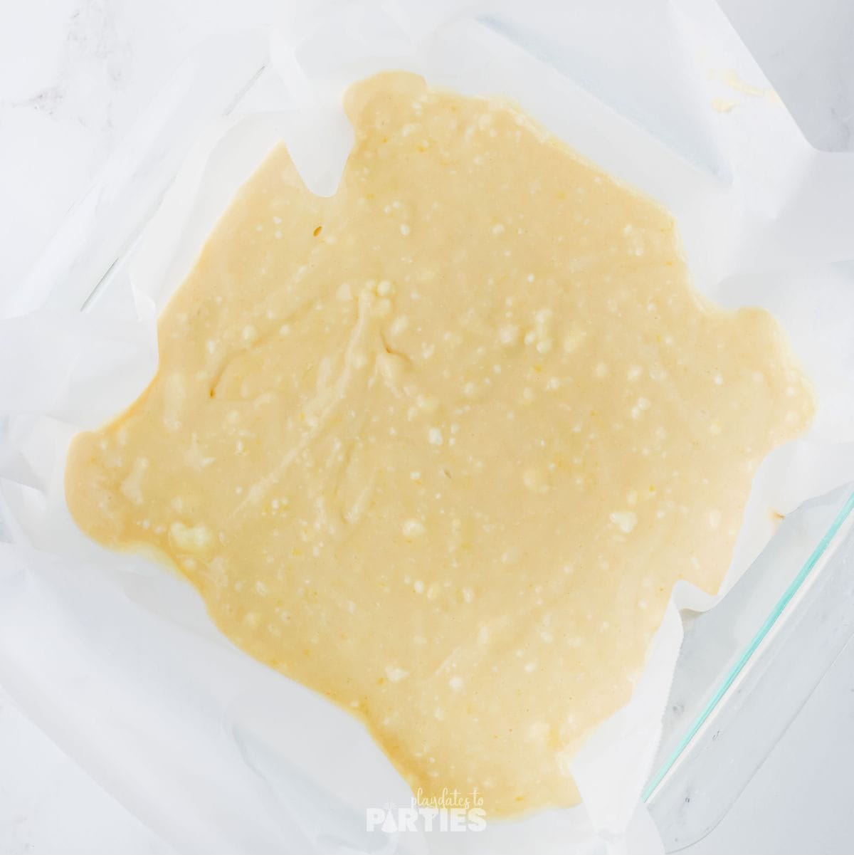 Cake batter in a 9x9 pan.