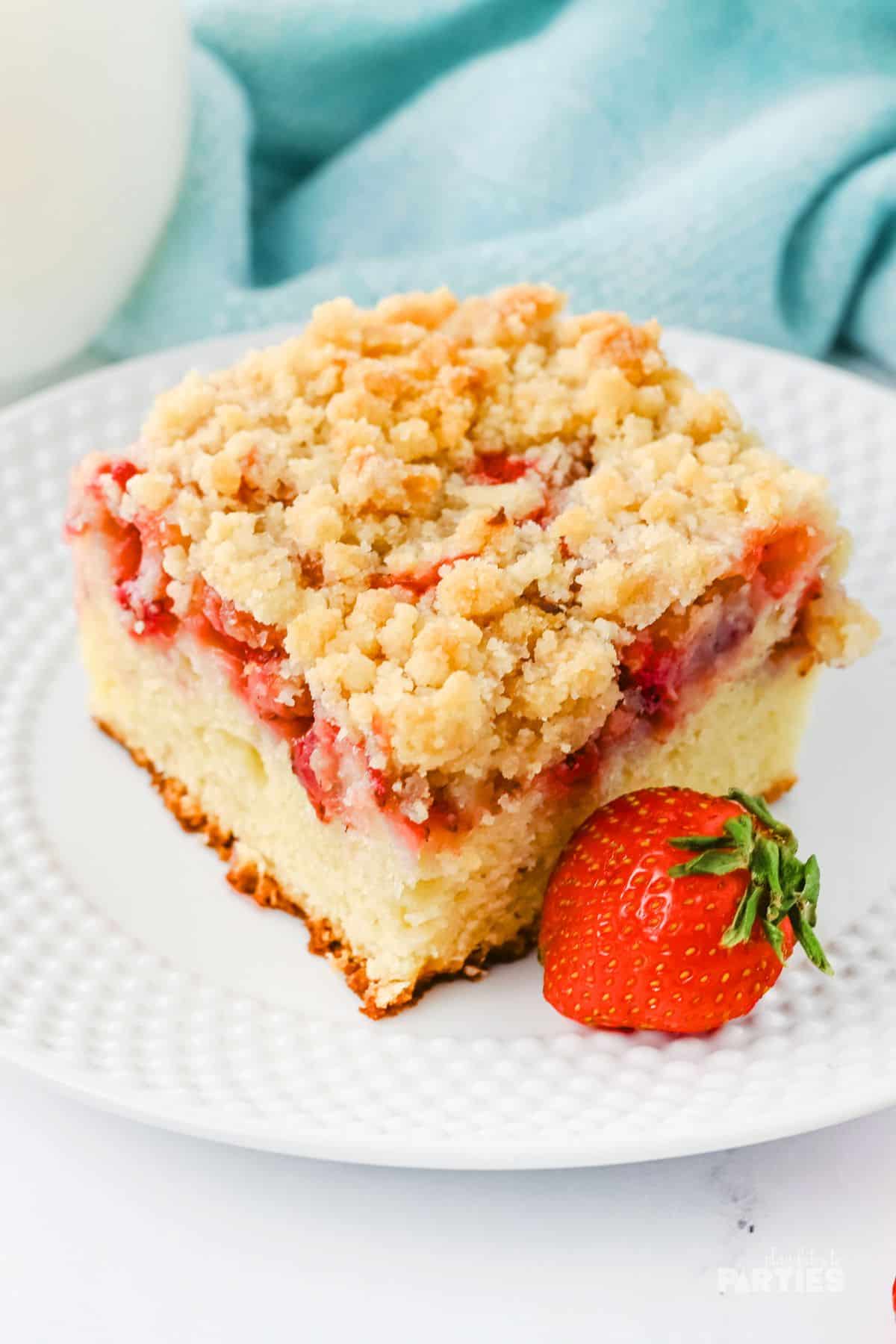 The soft coffee cake is layered with fresh strawberries and buttery crumble.