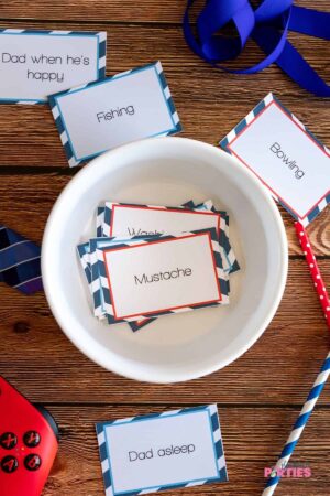 A white bowl filled with Father's Day Charades cards.