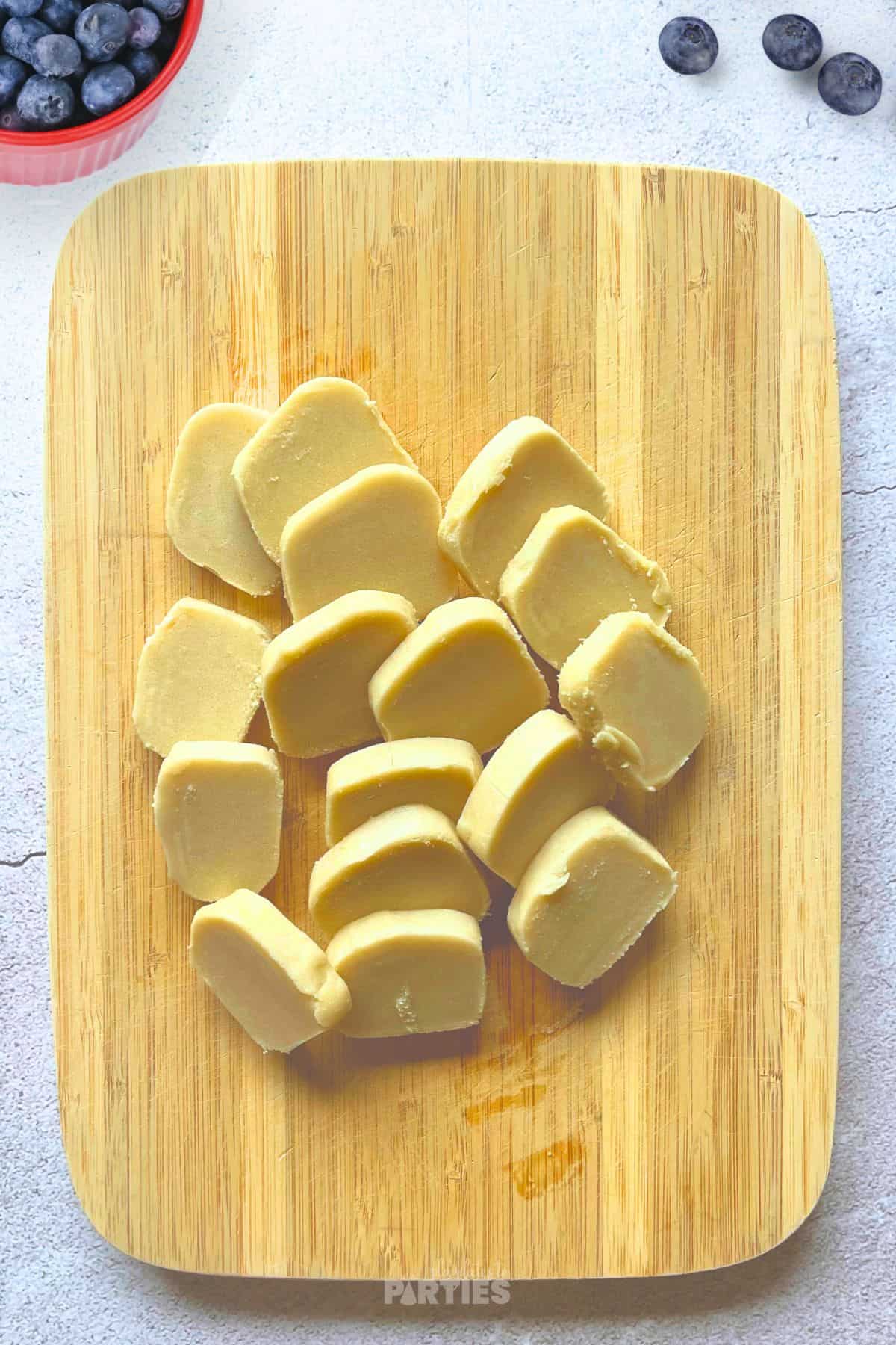 Cutting sugar cookie dough into rounds.