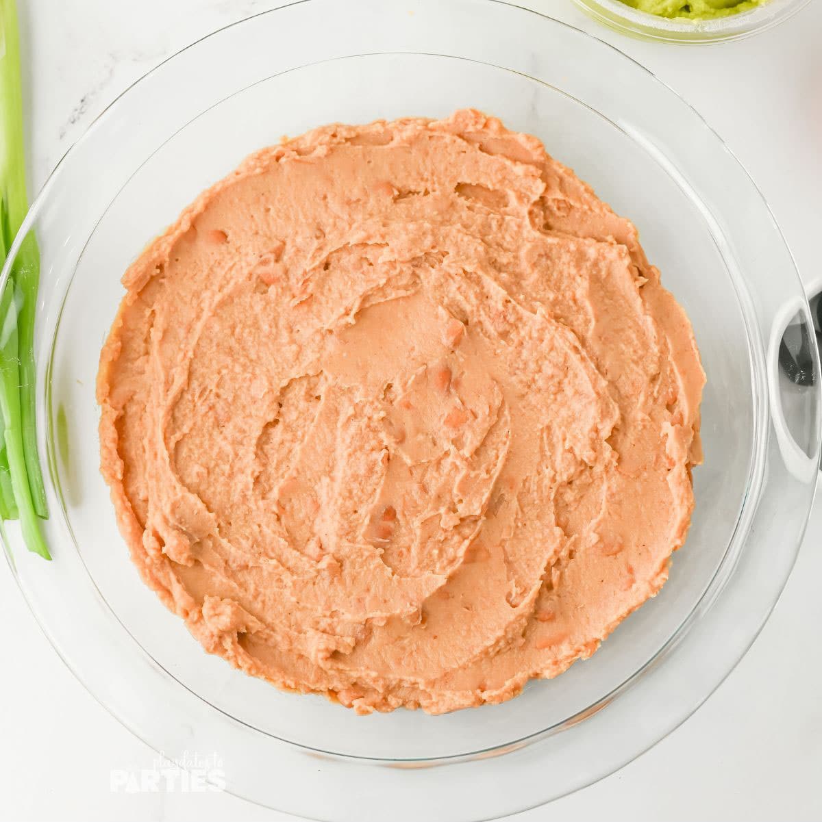 Baked bean layer in a pie pan.