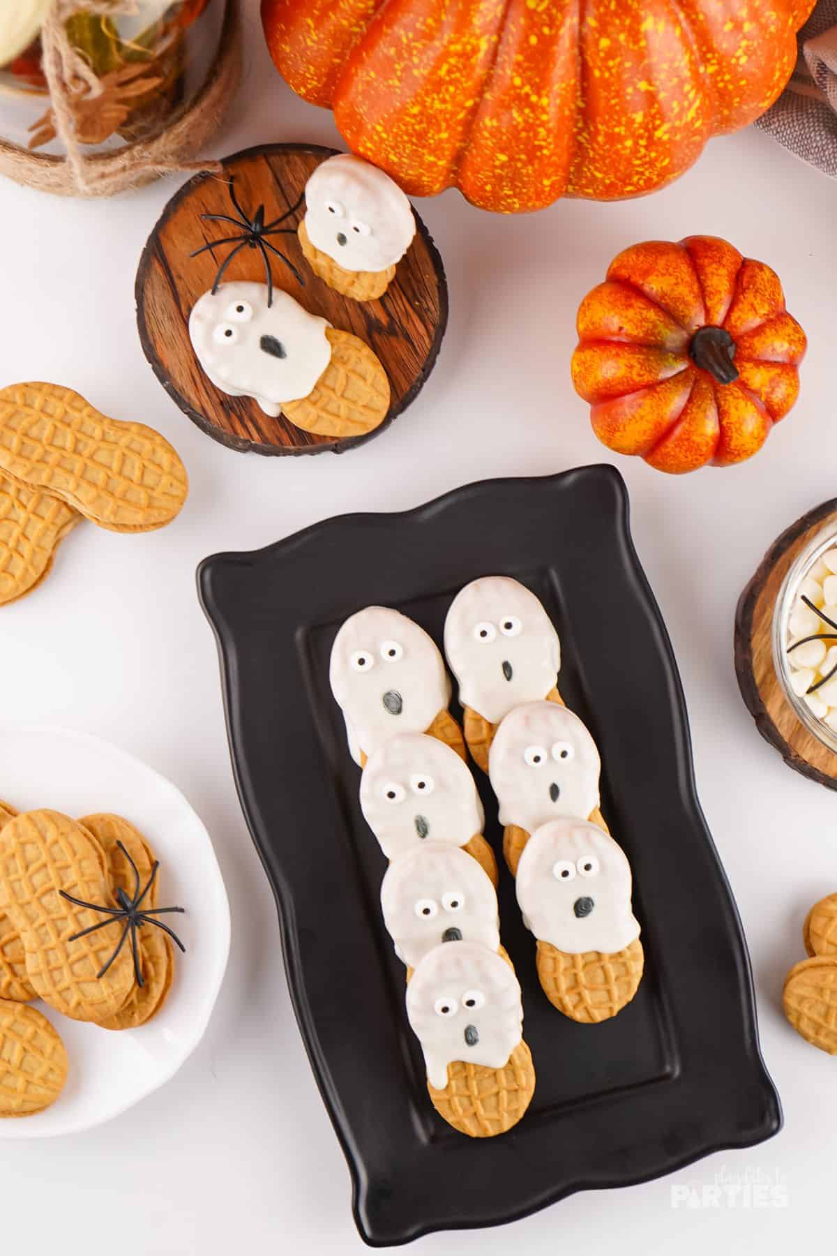 A black party platter with Nutter Butter cookies decorated to look like ghosts.