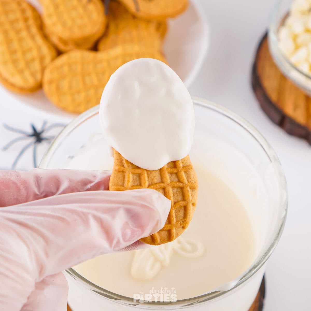 Tilting a cookie to let the chocolate drip down.