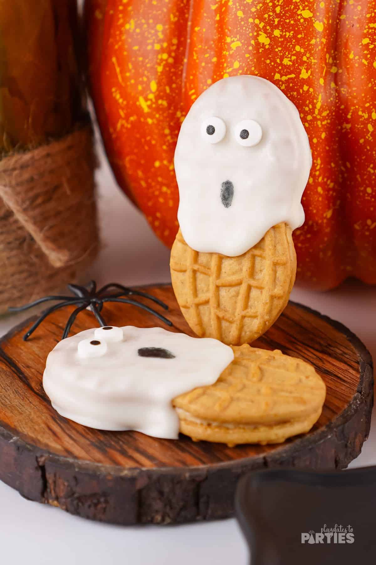 Two cookies decorated to look like ghosts.