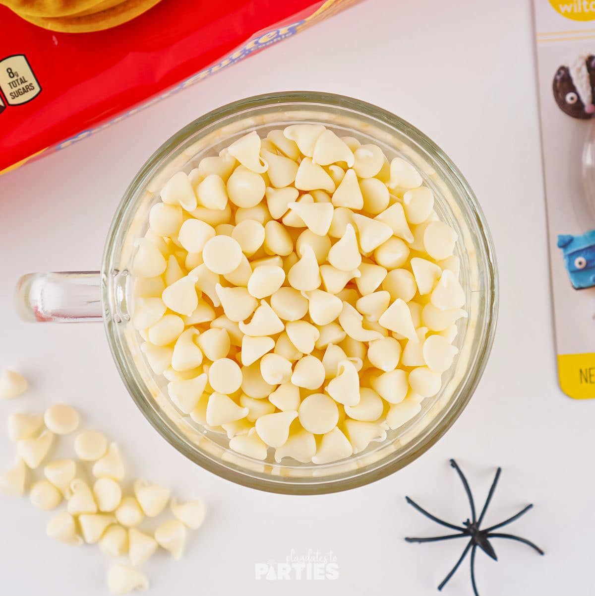 White chocolate chips in a glass measuring cup.