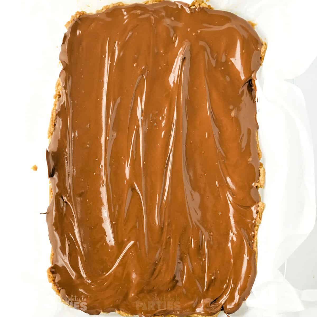 Melted chocolate spread on top of peanut butter.