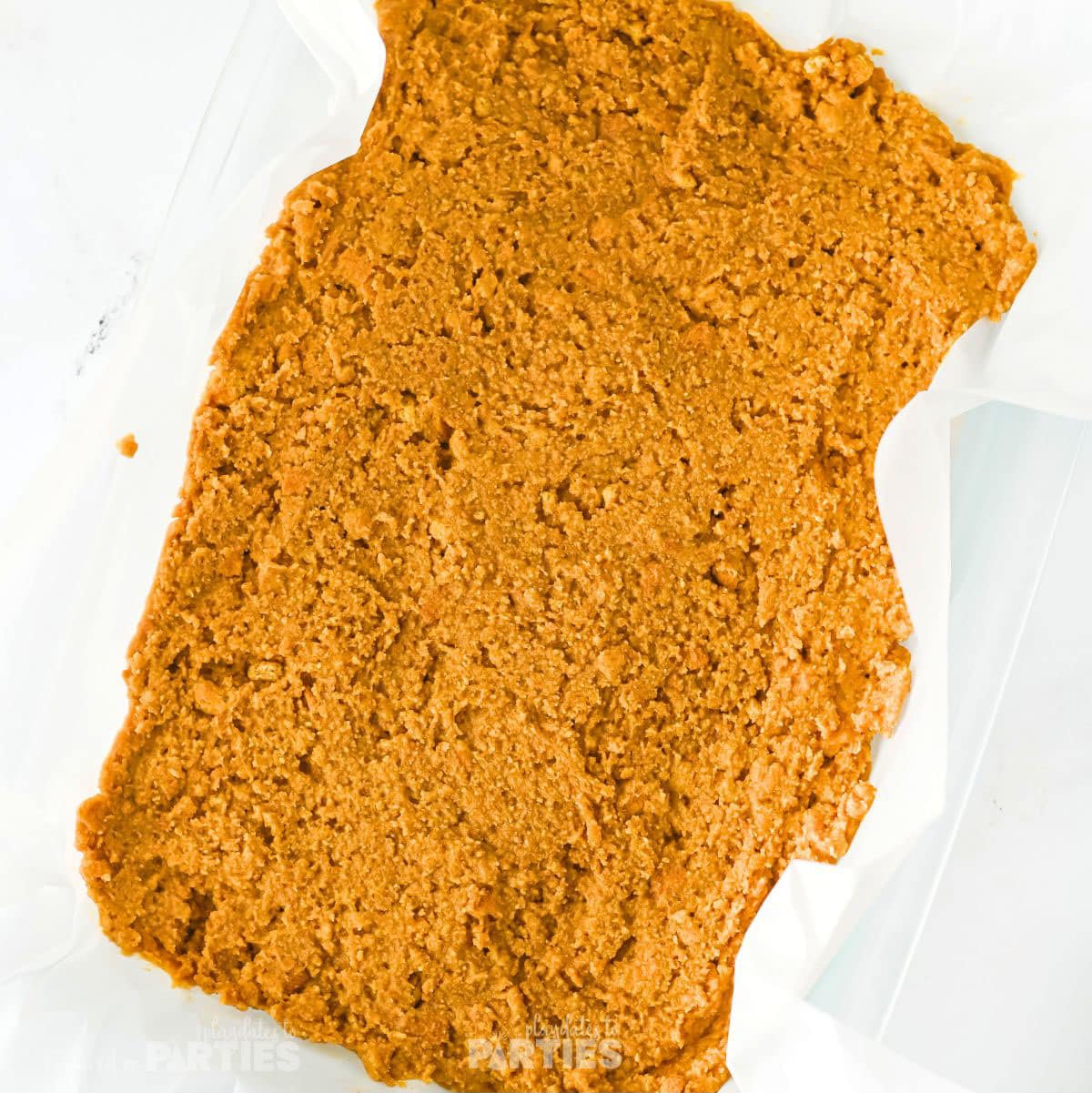 Peanut butter mixture spread in a pan.