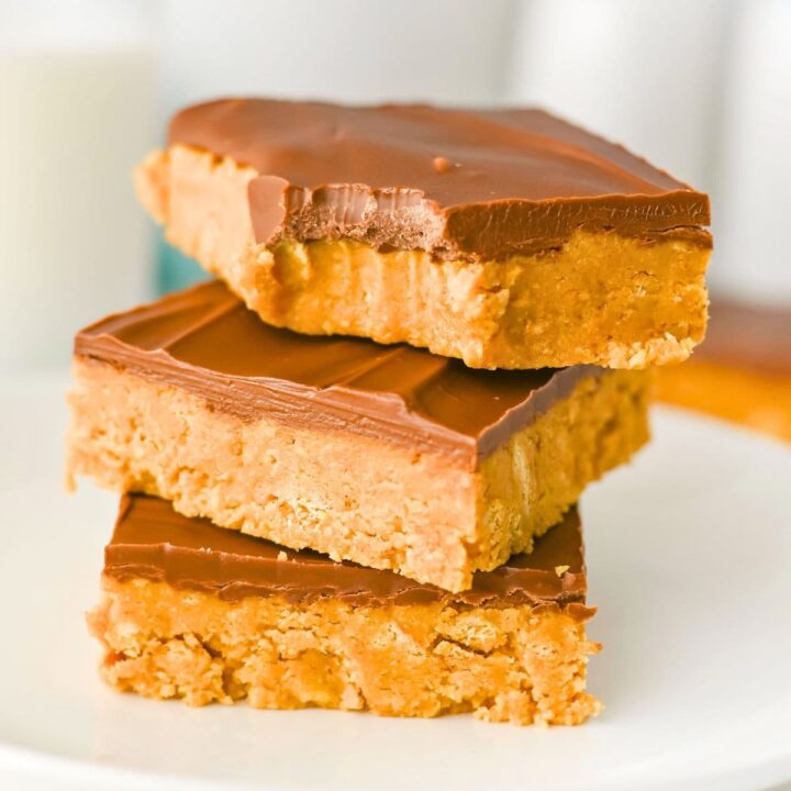 Three Peanut Butter Bars stacked on a white plate.